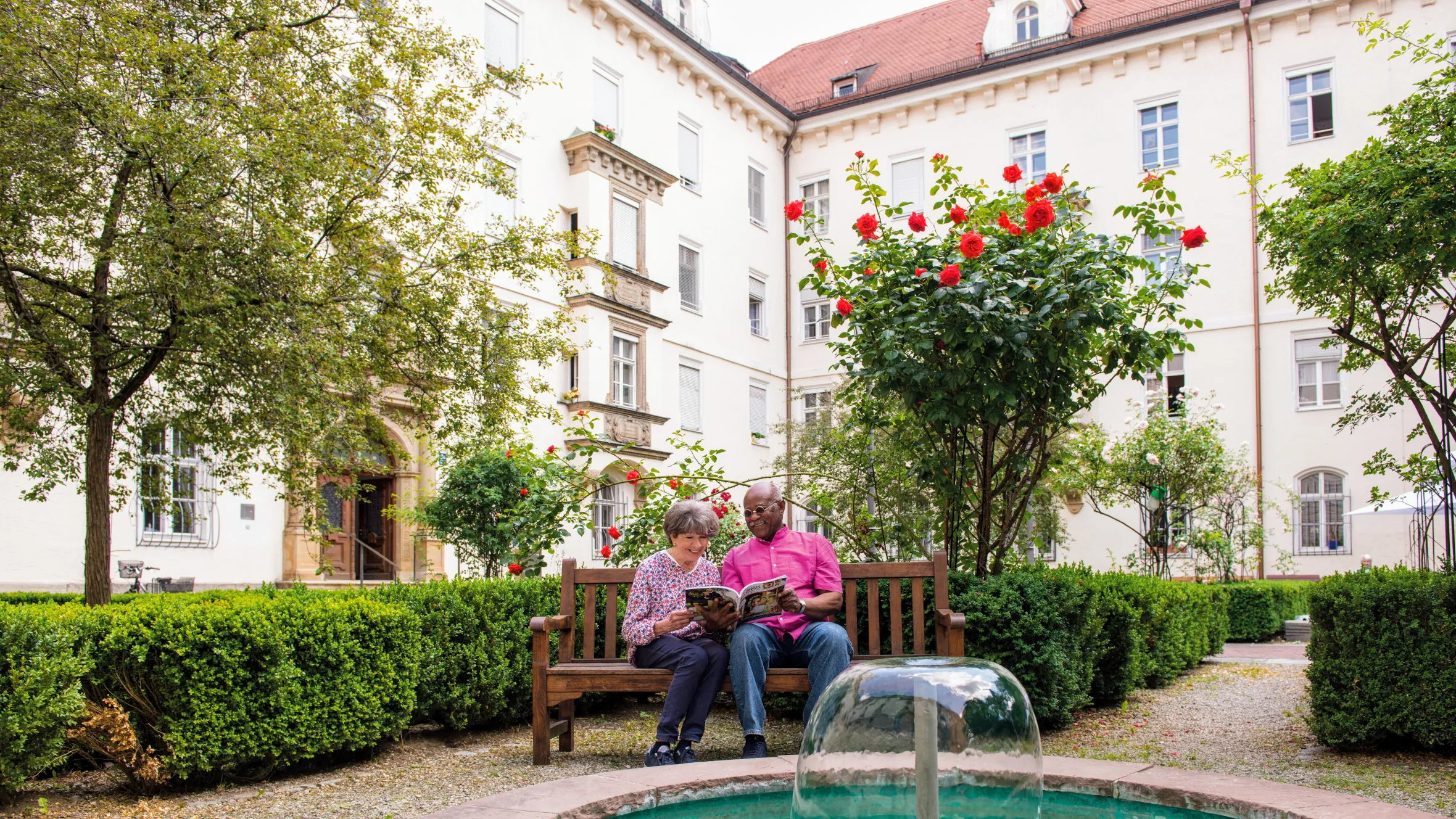 Resident couple reading the newspaper in the grounds of Mathildenstift