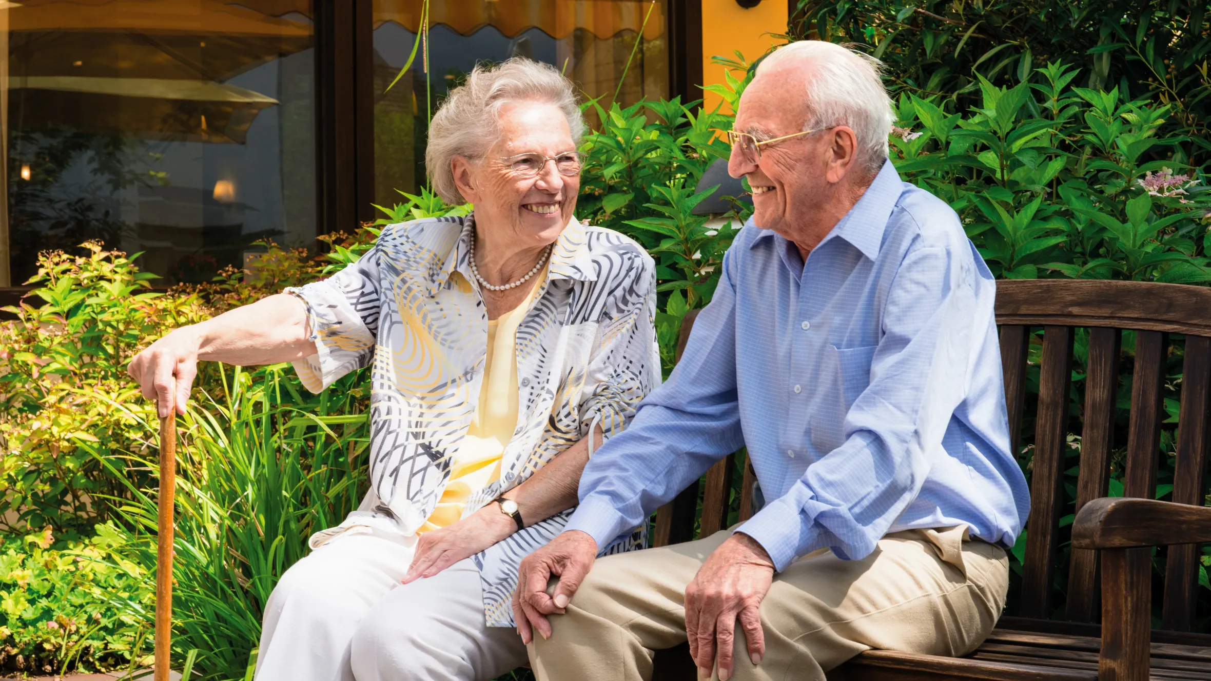 Resident couple on a bench in the garden