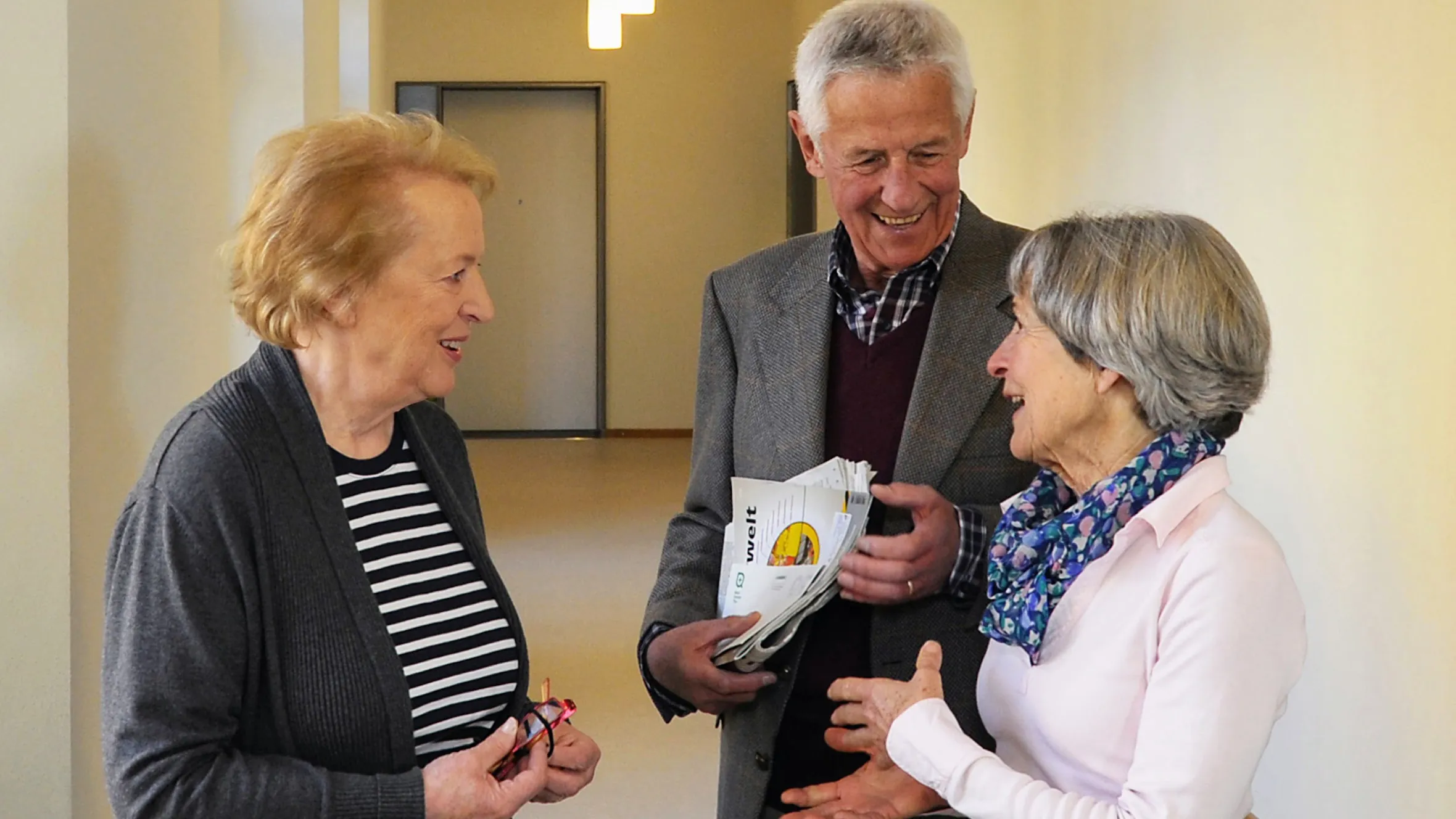 Three residents chatting in the corridor