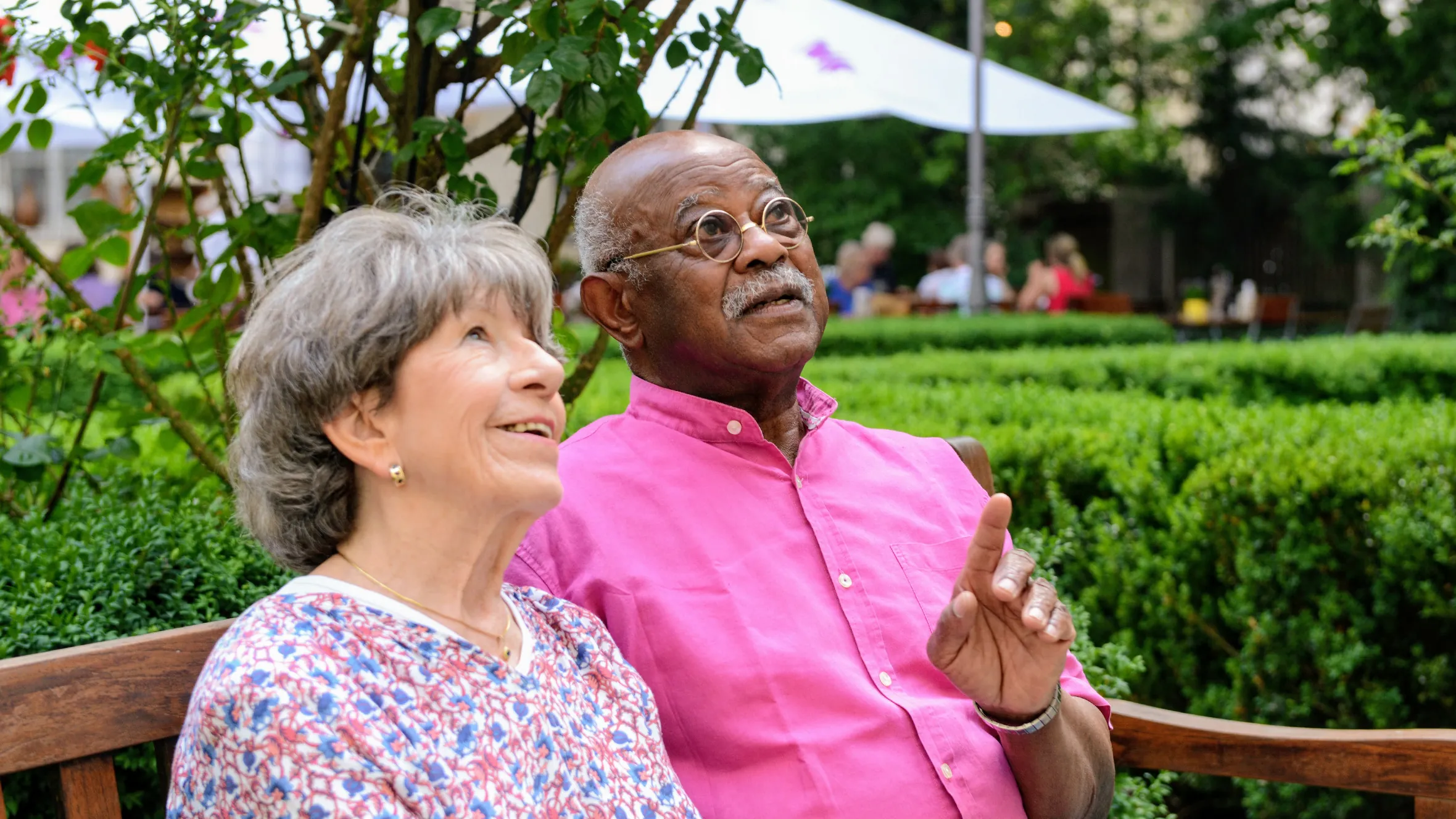 Resident with her husband in the courtyard of the retirement home